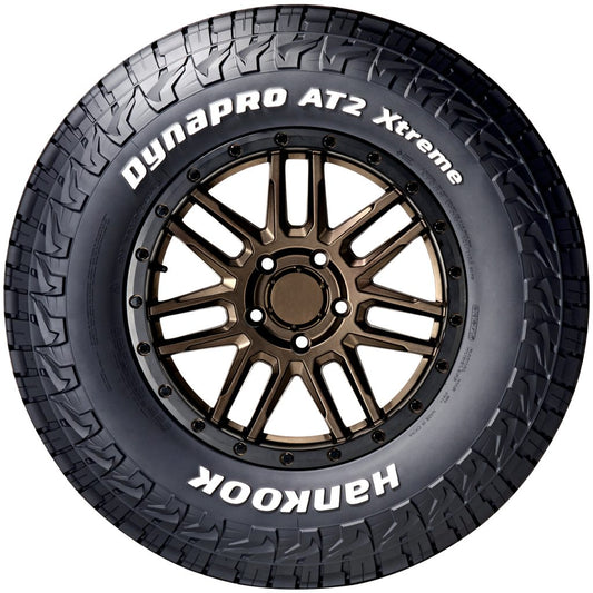 Hankook Dynapro AT2 Xtreme tire with bronze alloy wheel on a white background