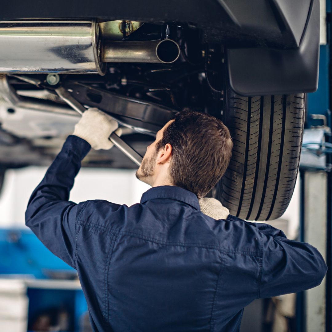 Mechanic examining car suspension